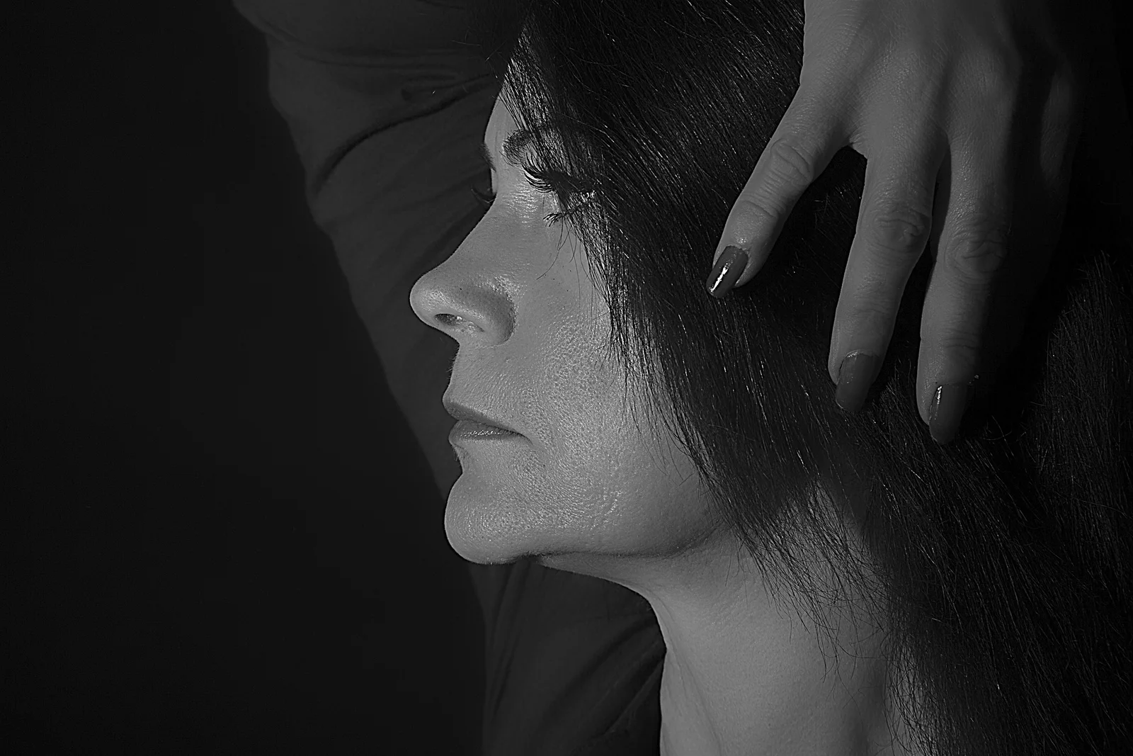 A hand becomes the visual weight at the centre of an ambiguous scene.