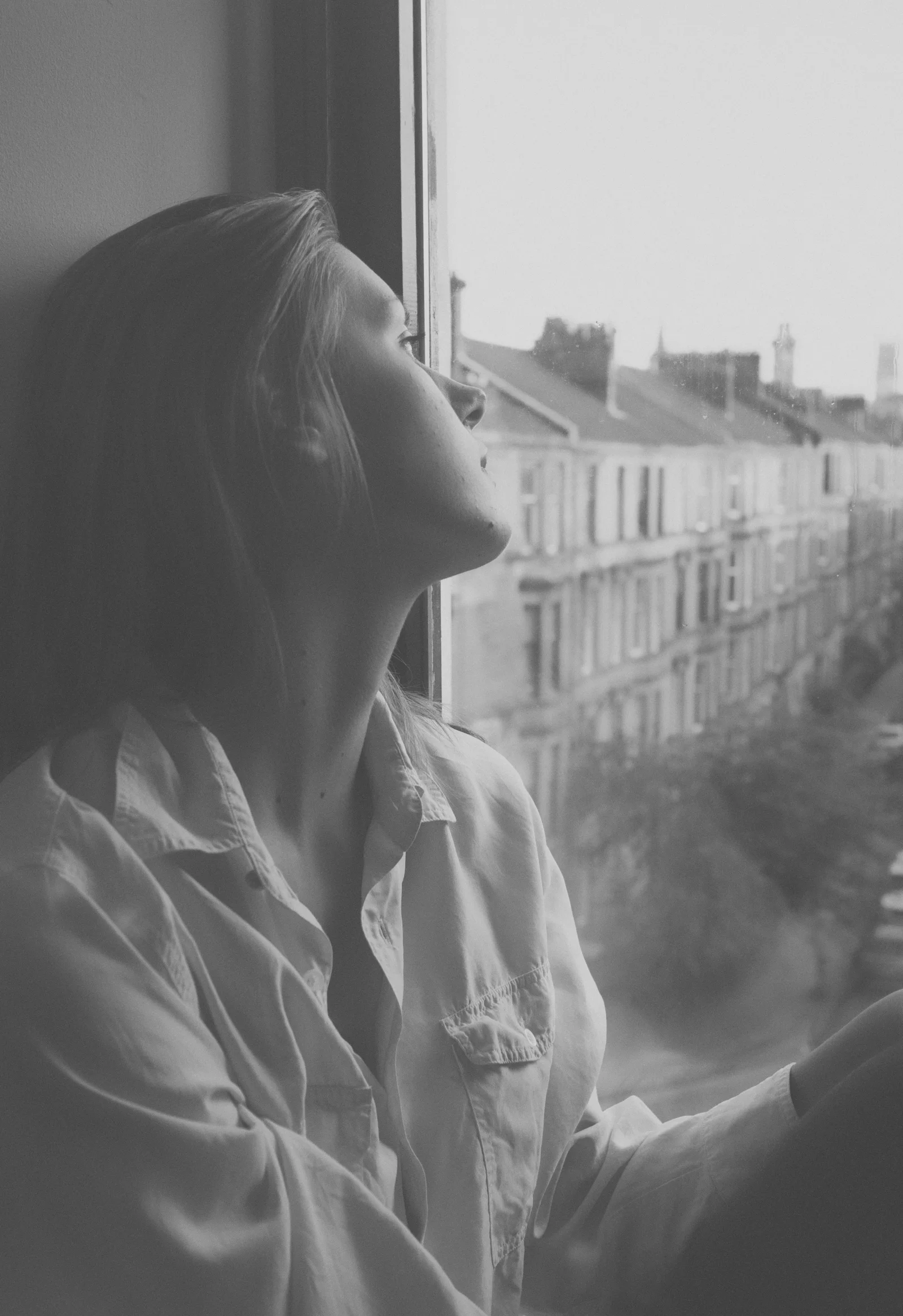 A lone person looks away towards another place beyond the frame.